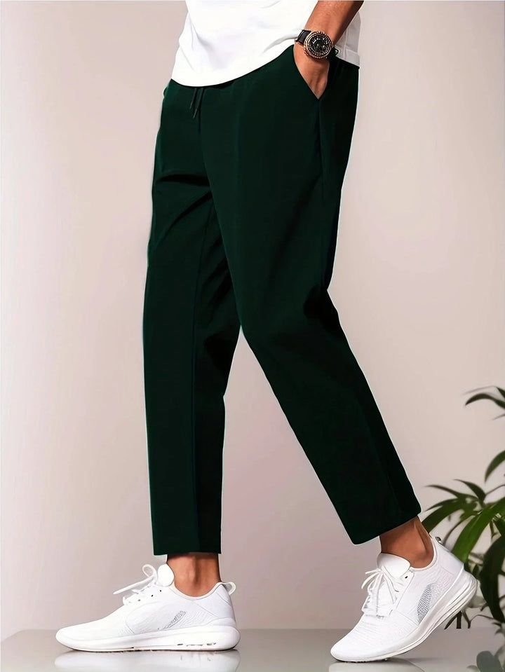 Flat lay of all three color options — grey, black, and deep blue — of lightweight casual pants
