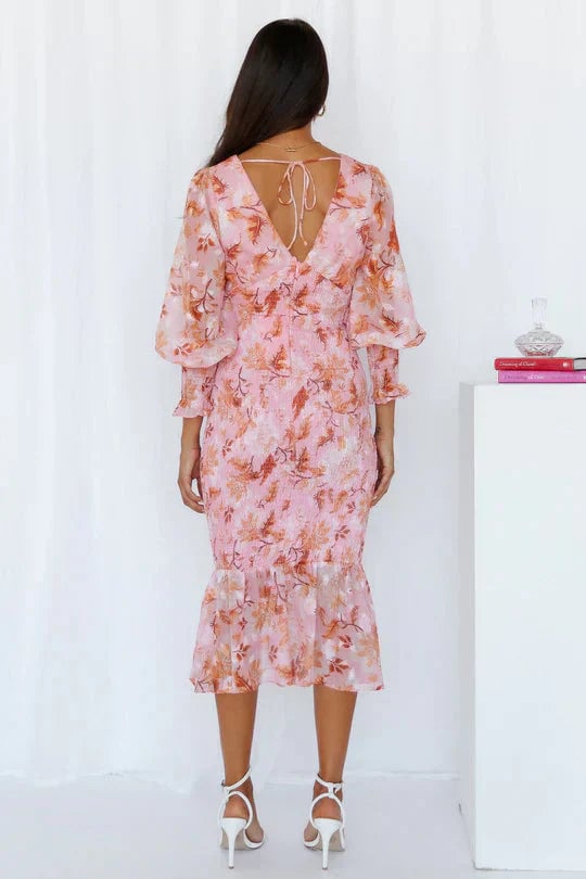 Woman wearing the Gabrielle floral draped dress in green, full-length front view