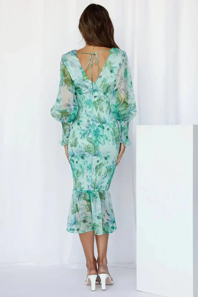 Side profile of the Gabrielle floral flowy dress in green showing the flattering fit