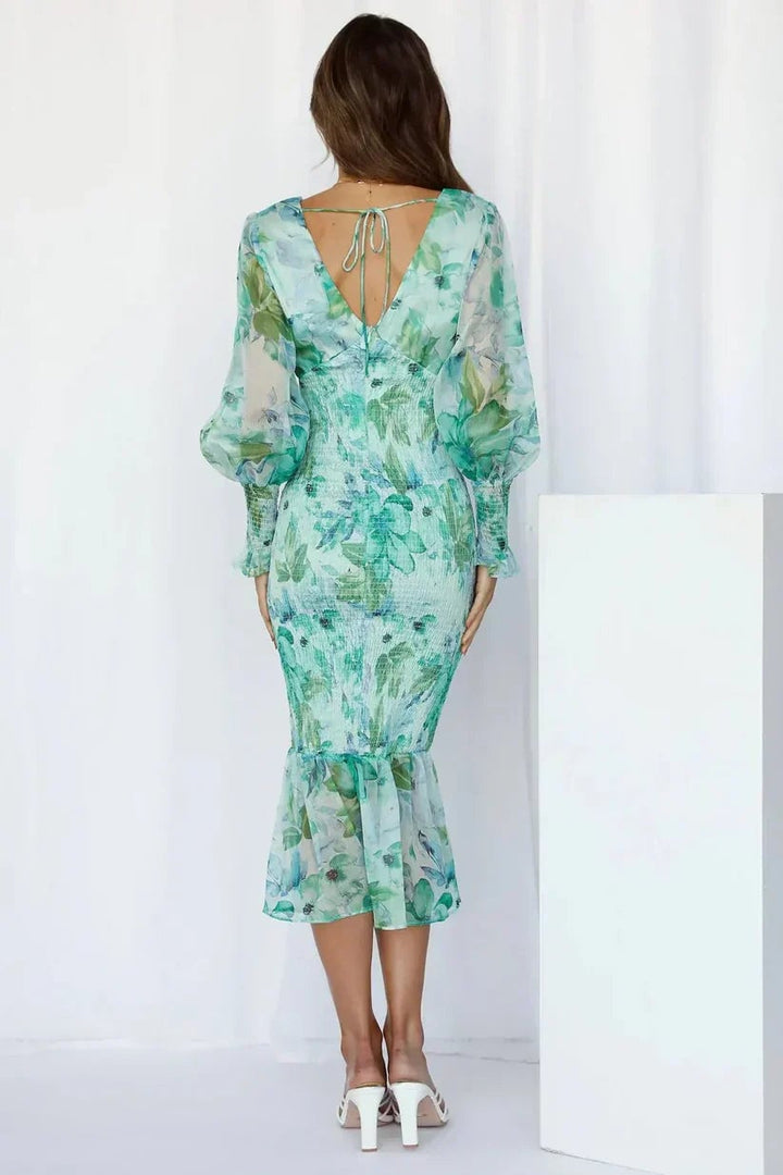 Side profile of the Gabrielle floral flowy dress in green showing the flattering fit