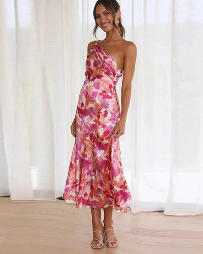 Woman wearing the Genevieve floral asymmetric midi dress in orange with a flowing silhouette