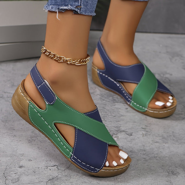 Flat lay of all four Giselle sandal color options: blue, black, green, and orange