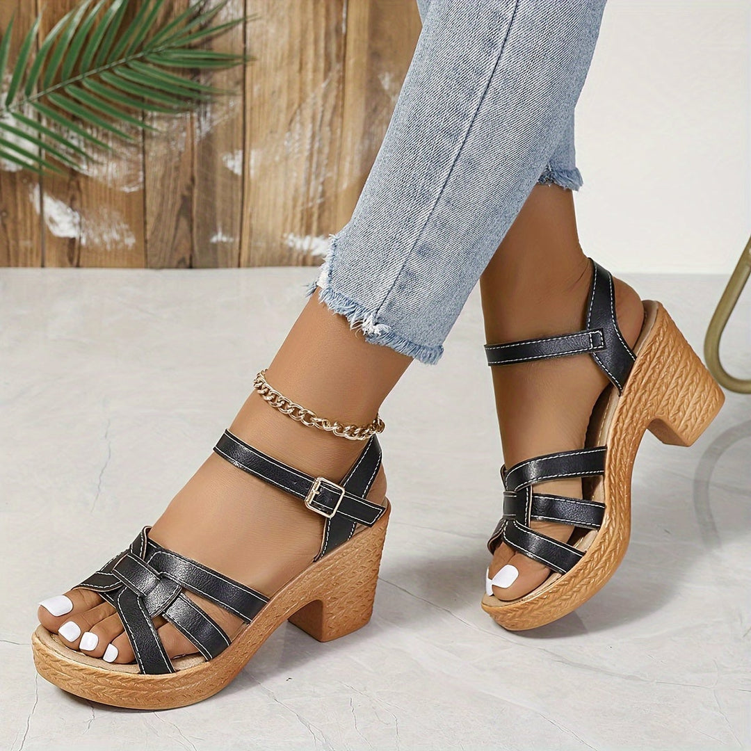 Model walking in Greta wedge sandals in sea blue on a sunny outdoor path