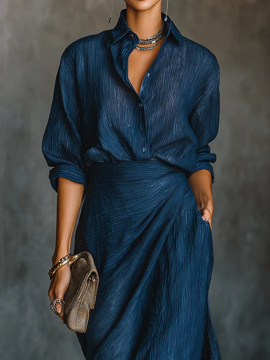 Close-up detail of the dark blue shirt and maxi skirt set, highlighting the rich color and fabric drape