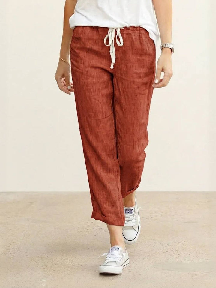 Close-up of elastic drawstring waistband on Harper pants in apricot