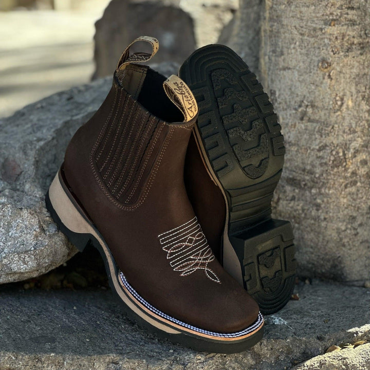 Haven cowboy boots in dark brown displayed from the side to highlight the heel height and shaft design