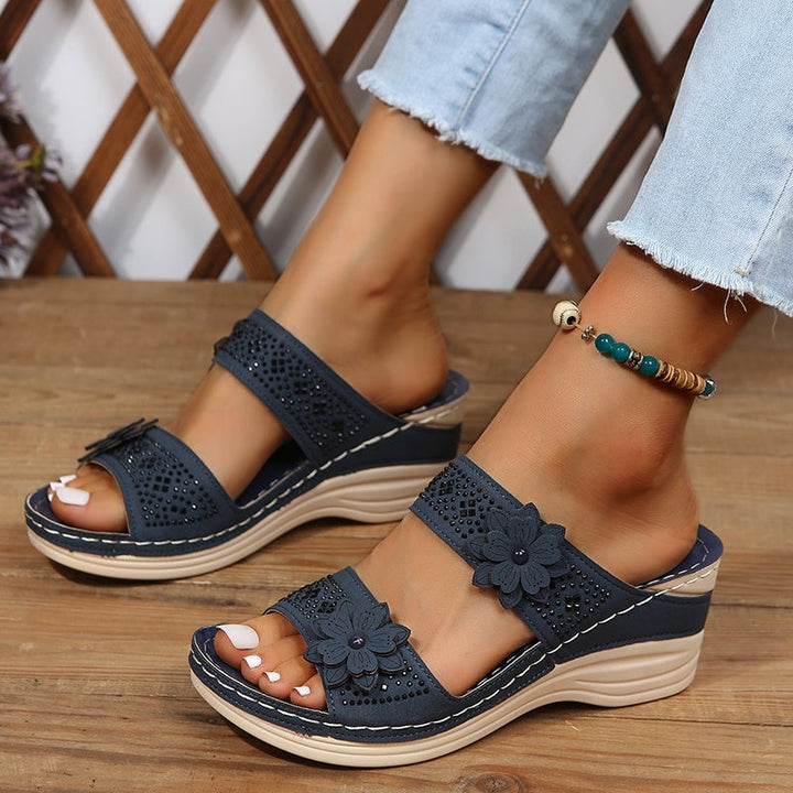 Heath women's wedge slides in black, three-quarter rear view showing heel height