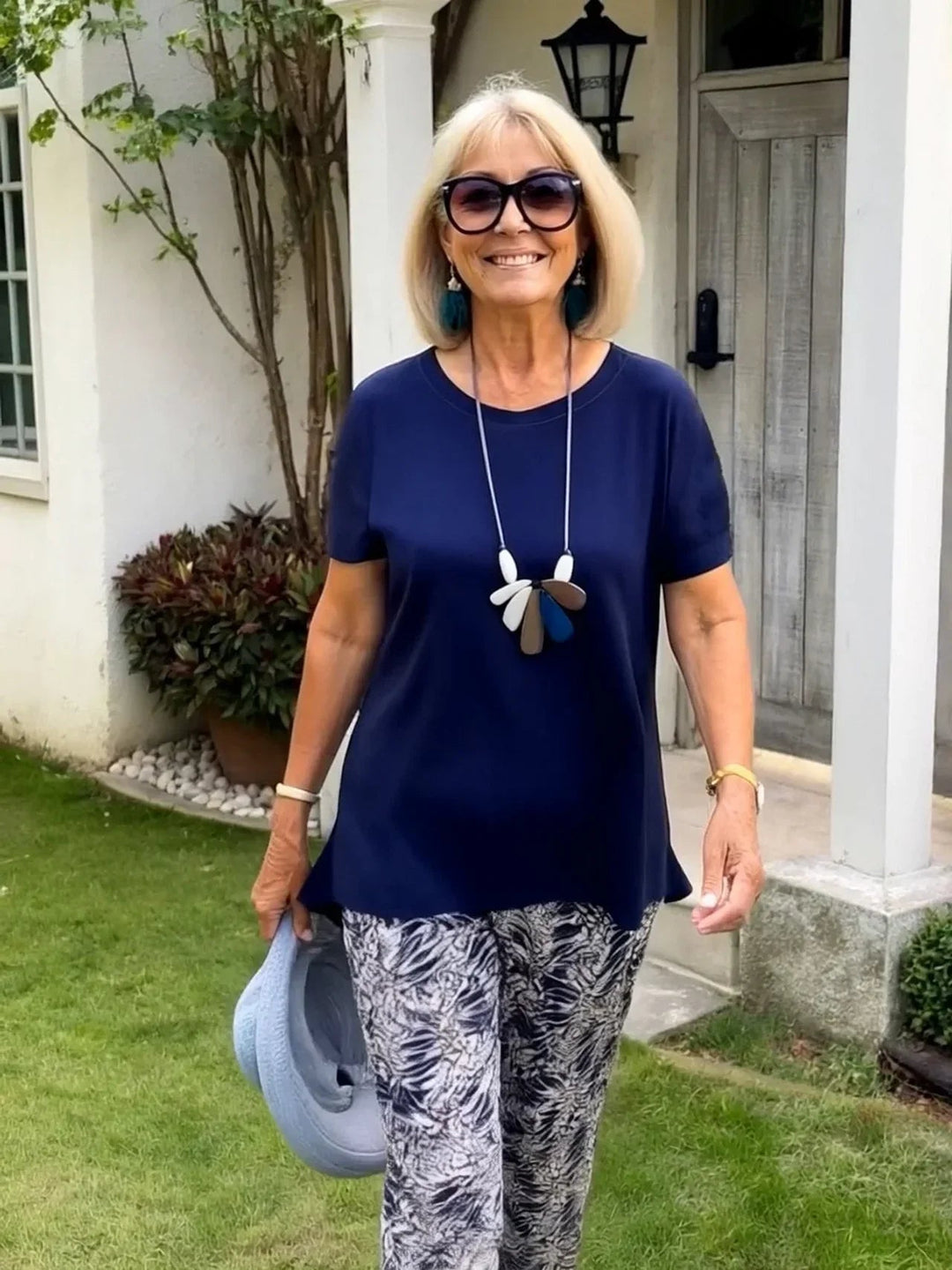 Full-length shot of a woman in the BobaFashion Coastal Set paired with strappy sandals on a sunny day