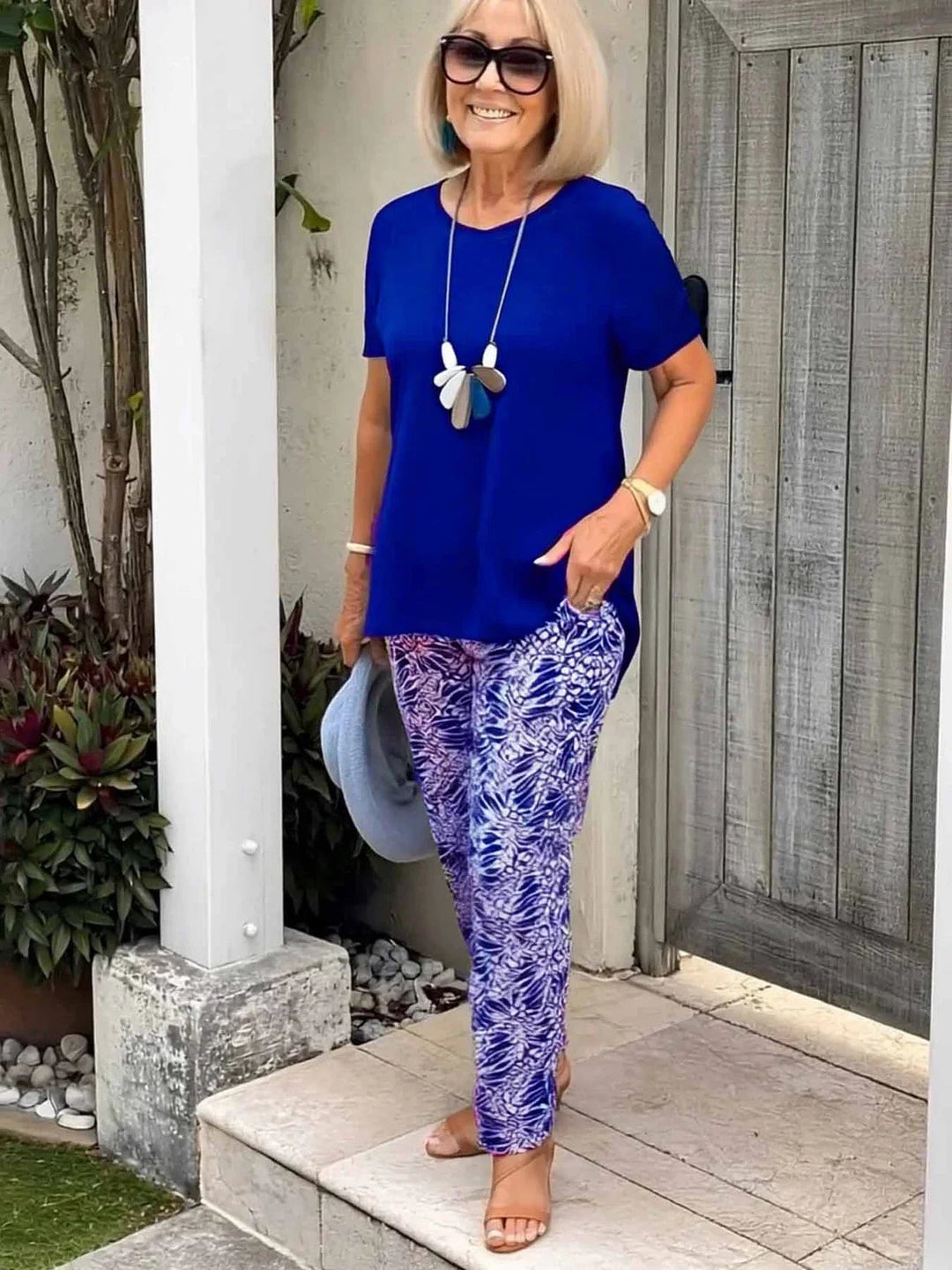 Detail shot of the artistic pattern on the BobaFashion Coastal Set blouse in blue