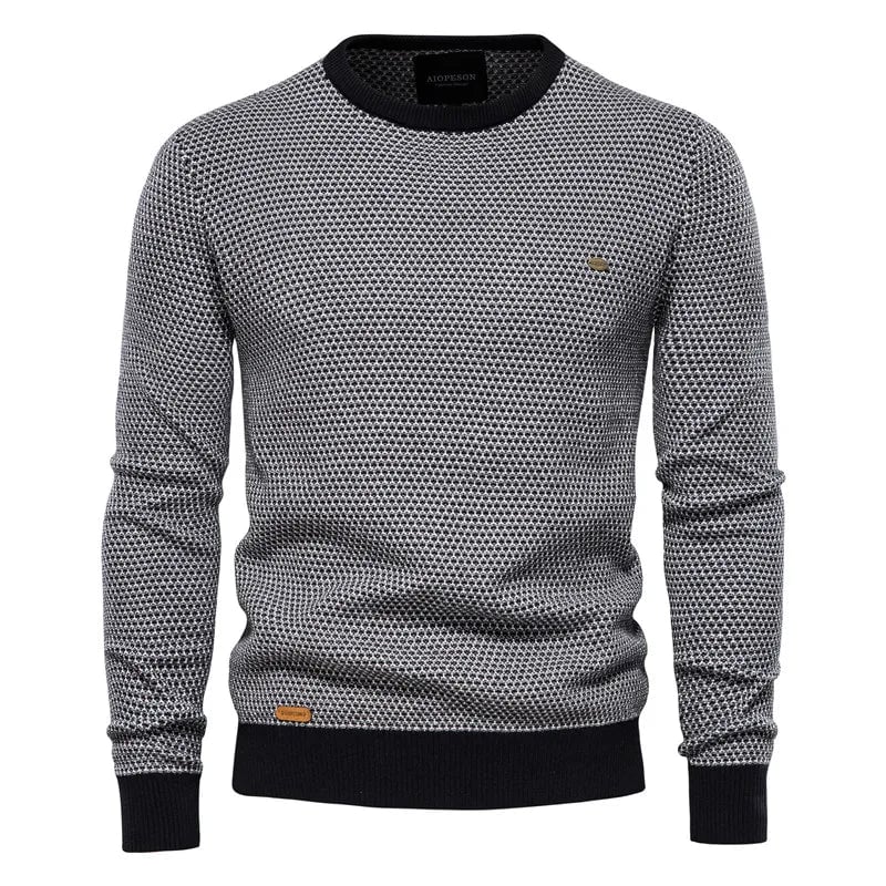 Close-up of checkered pattern and ribbed hem detail on a men's knit sweater