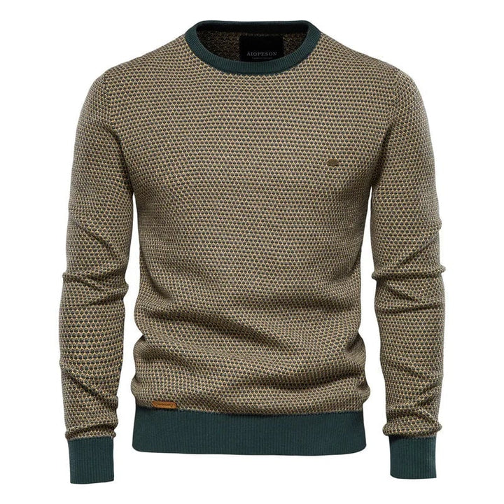 Full-length view of men's checkered sweater styled with dark trousers