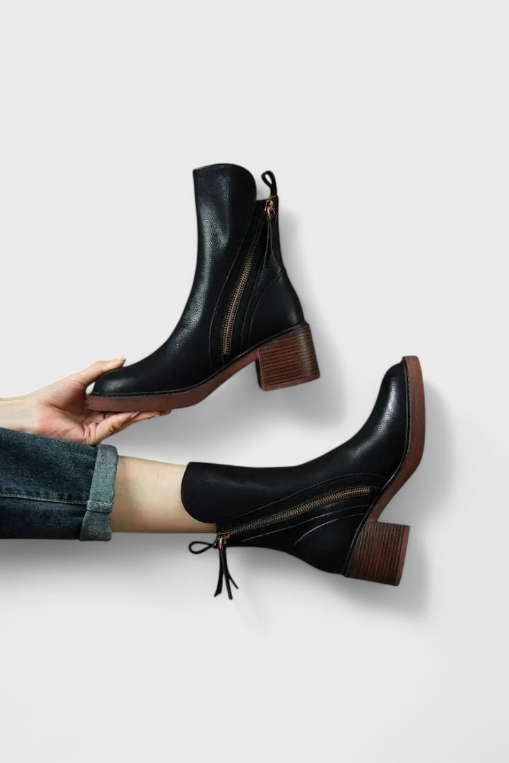 Irina sleek ankle boots in black with a streamlined silhouette, front view on white background