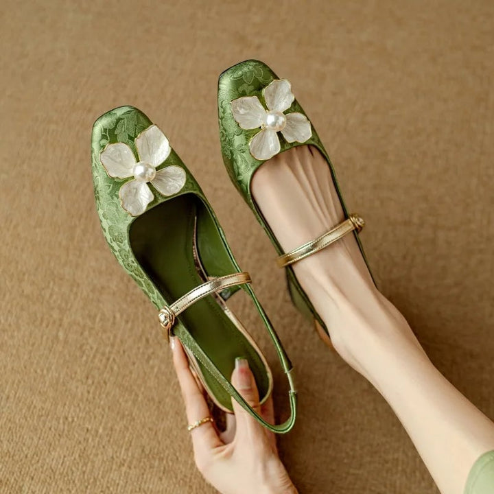 Close-up of pearl floral embellishment on Isabeau mary jane pumps in green