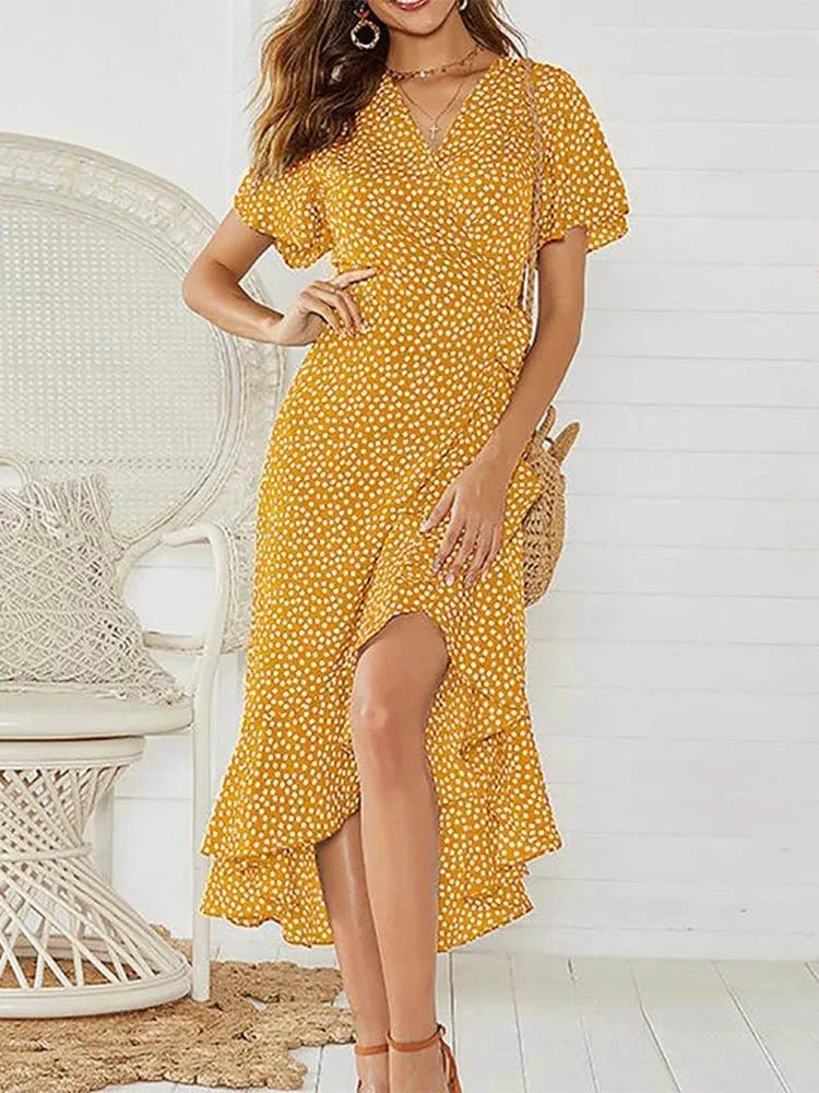 Woman in a white floral maxi dress accessorized with sandals for a beach-ready summer look