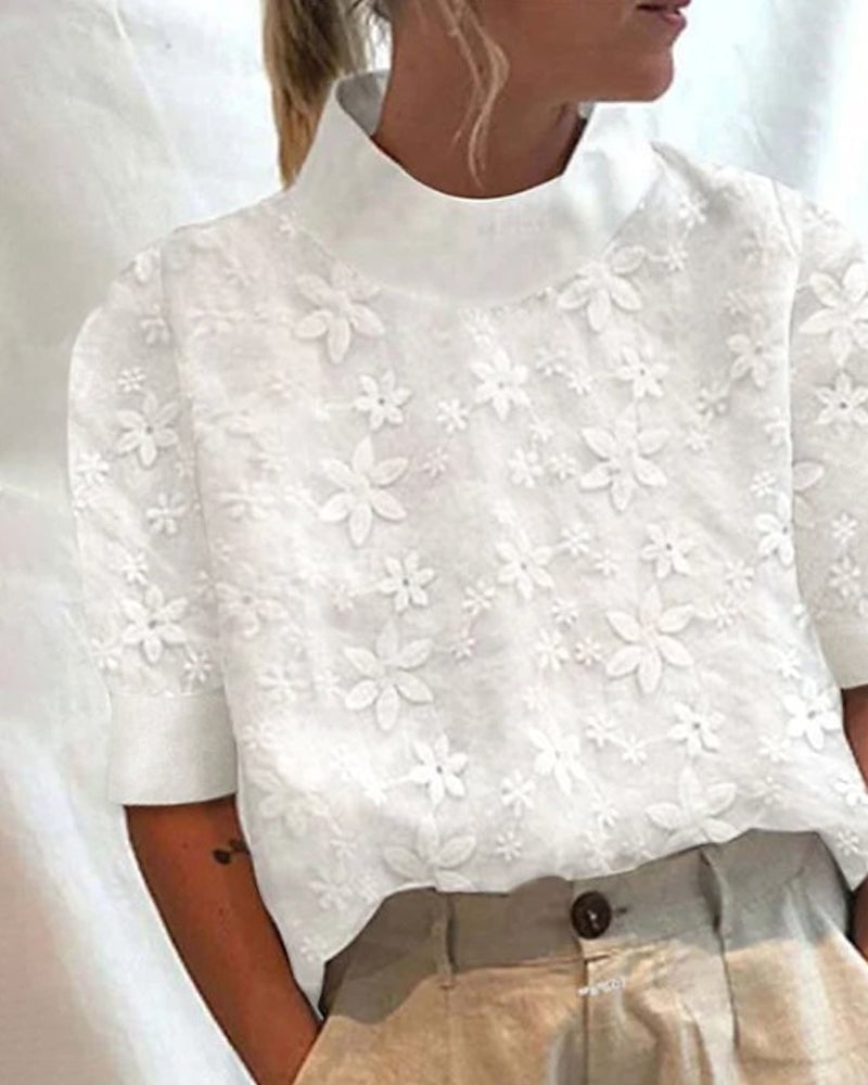 Front view of a white stand-up collar blouse with subtle floral texture detailing
