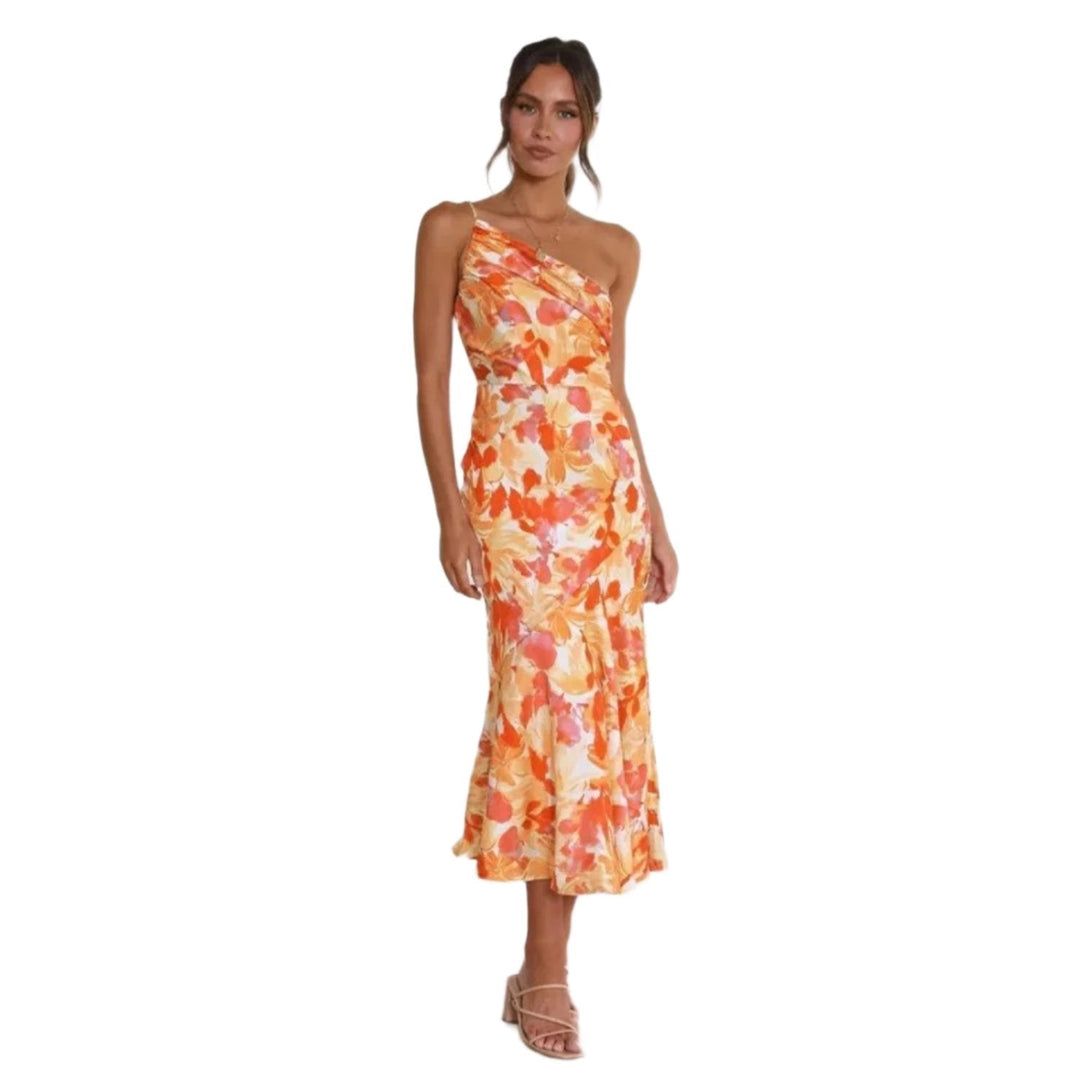 Back view of a woman in an orange floral asymmetrical maxi dress