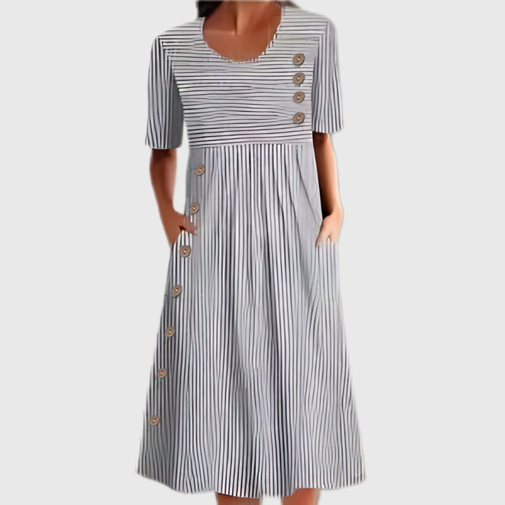 Close-up of the striped pattern and button detail on the midi dress in blue and gray