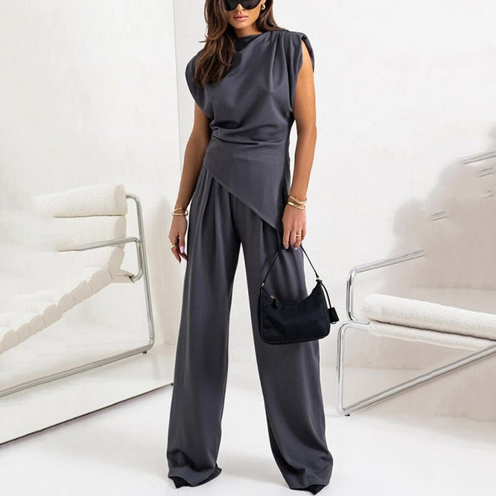 Model walking in the Khloe wide-leg set in white showing fluid fabric movement