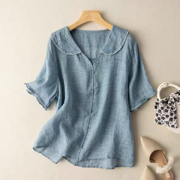 Full-length view of a woman in a loose airy vintage blouse styled with casual bottoms