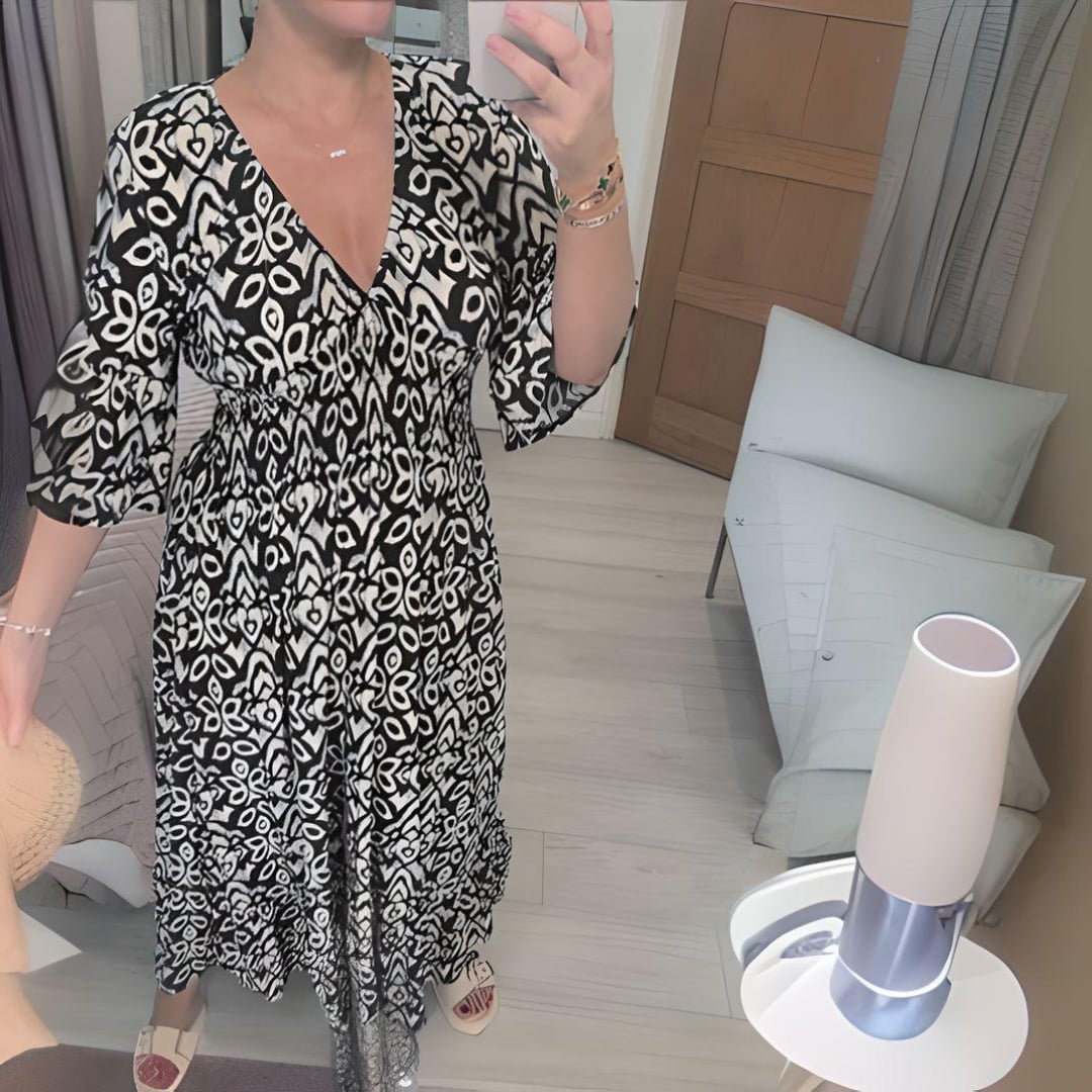 Front view of the Lennox long flowy maxi dress showing the elegant flare sleeves and fluid silhouette