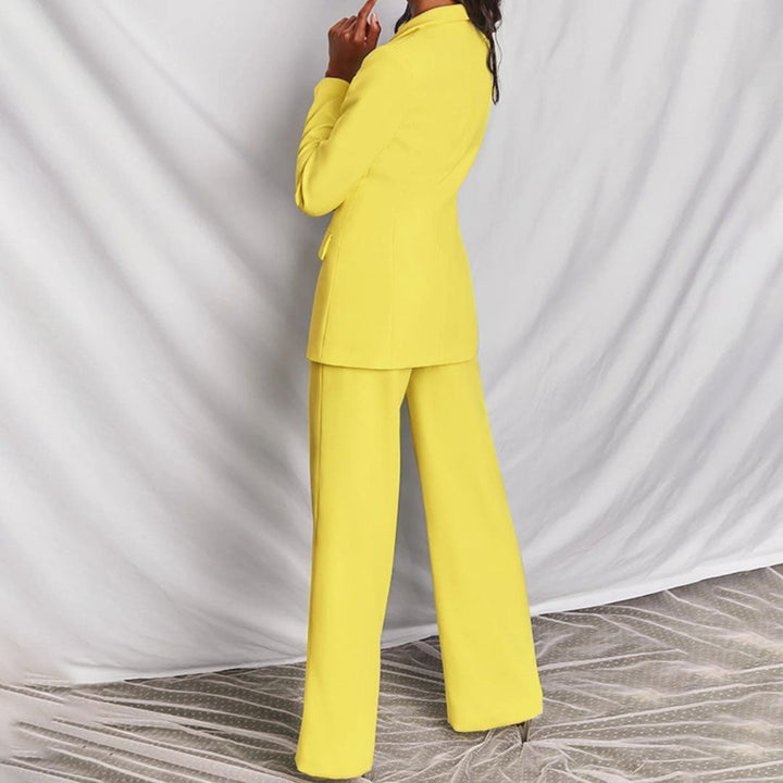 Side profile of model in the BobaFashion structured blazer and high-waisted trousers set