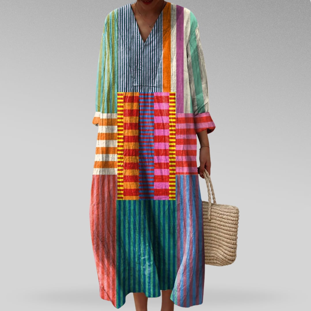Model wearing the Lia elegant geometric print dress with a flowing silhouette in a bold dream-inspired pattern