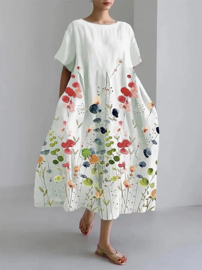 Woman wearing a white floral long dress with a relaxed, fluid silhouette, styled for a casual summer day