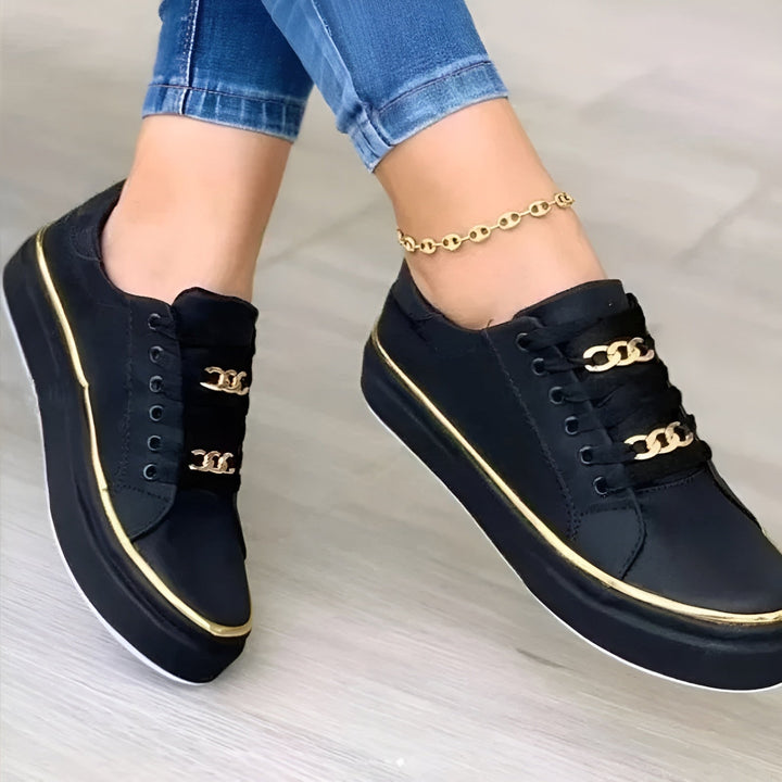 Luna platform sneaker heel and sole detail showing gold metallic edge trim, rear view