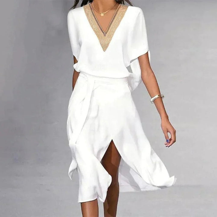 Side view of BobaFashion Lyra white midi dress showing flowing asymmetric hem and self-tie belted waist