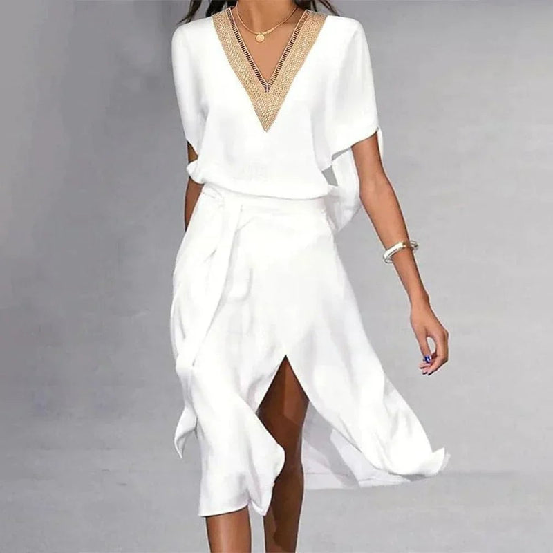 Side view of BobaFashion Lyra white midi dress showing flowing asymmetric hem and self-tie belted waist