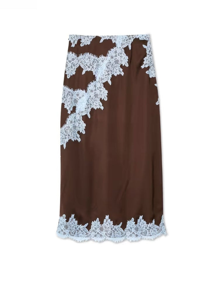 Model posing in the brown lace panel skirt set in a bright, airy setting