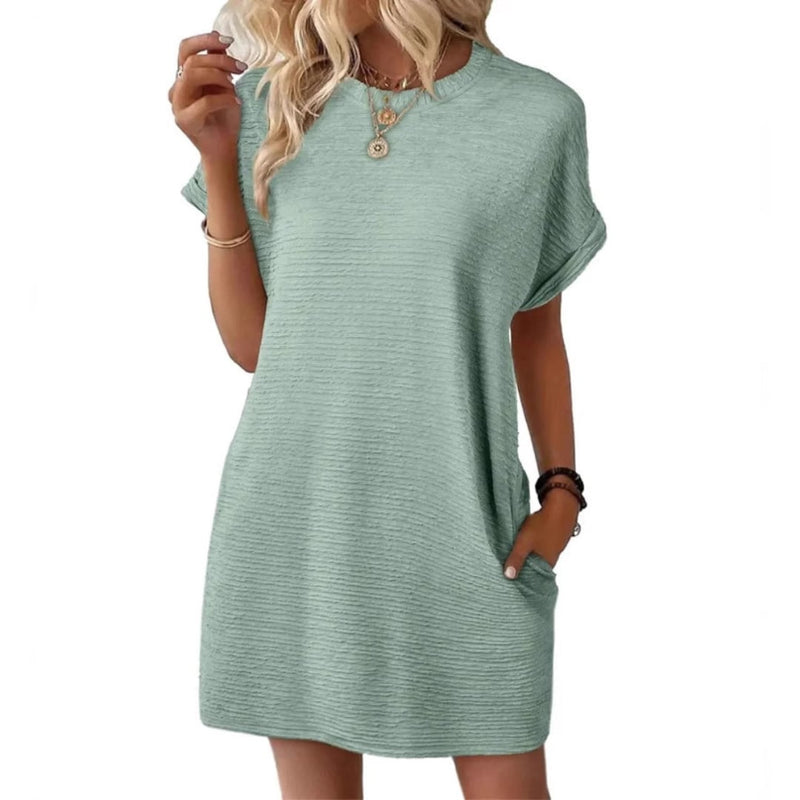 Side view of the Maggie mini dress in Light Green highlighting the side pocket detail