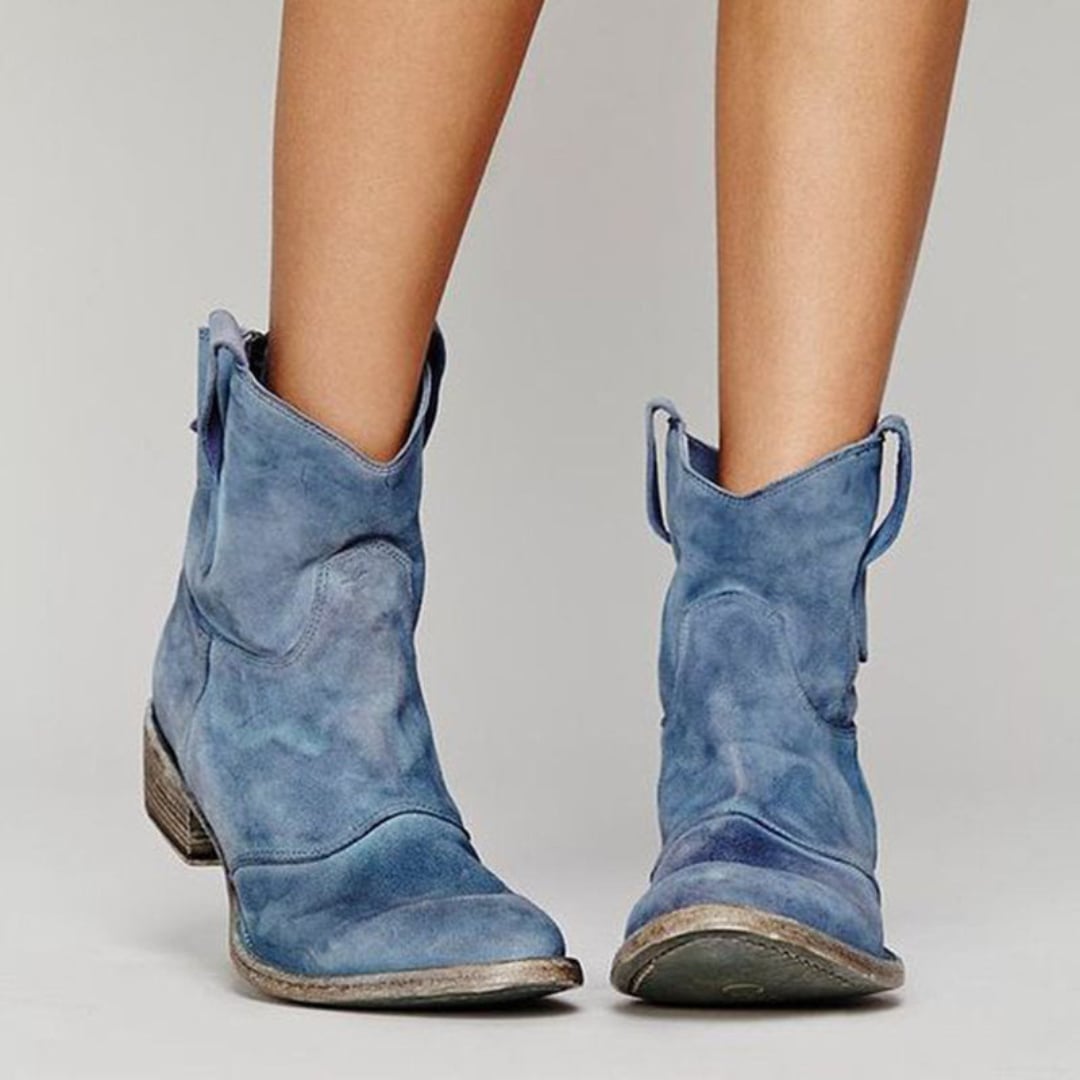 Side profile of women's suede ankle boots highlighting the leg-lengthening cut