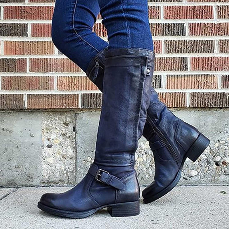 Women's knee-high boots styled with a midi skirt for a polished fall outfit
