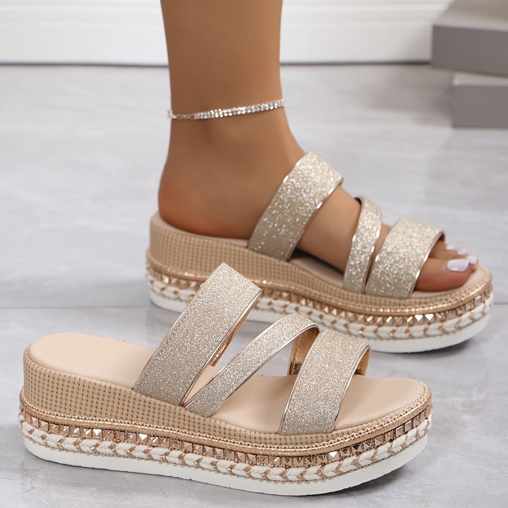 Side profile view of the Mira beige women's flat sandals highlighting the delicate strap detail