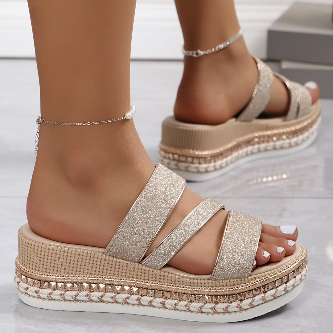 Top-down view of the Mira beige flat sandals showing the full footbed and strap layout
