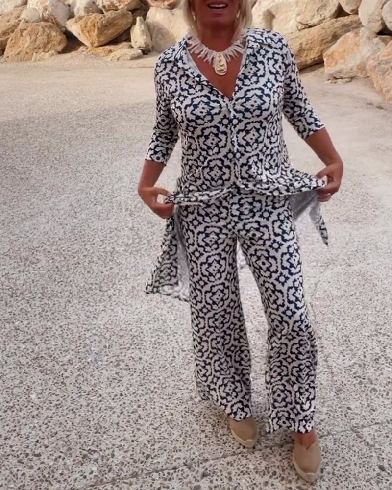 Woman wearing the Mosa two-piece set in navy blue geometric print, front view
