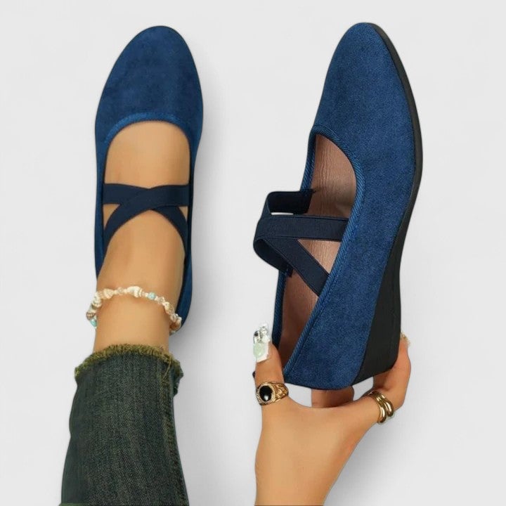 Nadia cross-strap wedge flats styled with wide-leg trousers, shown in multiple color options including red and blue