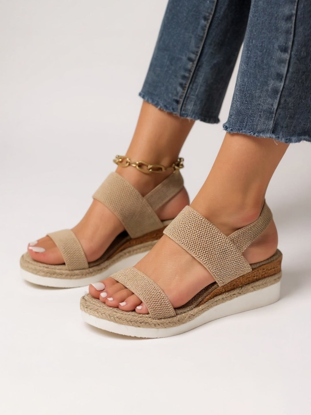 Neve women's sandals in pink shown on a model's feet walking on a light surface