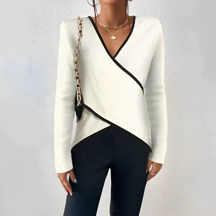 BobaFashion Nora ivory and black color block wrap blouse with deep V-neckline, asymmetric hem, and long fitted sleeves, worn by a woman