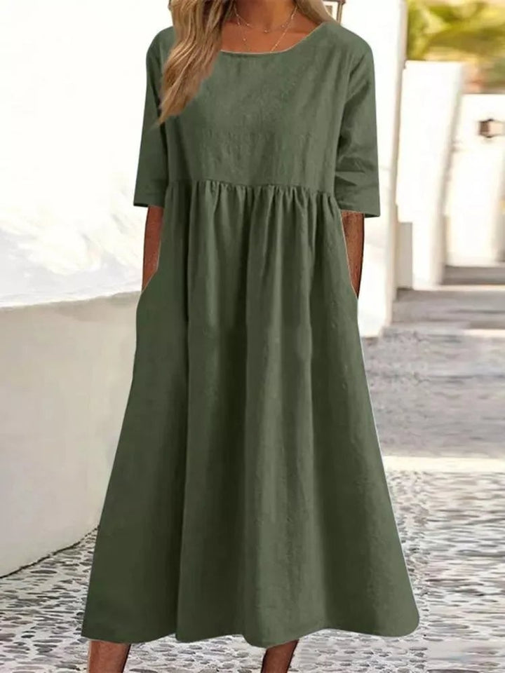 Front view of the Norah spring dress in navy blue, modeled with minimal accessories