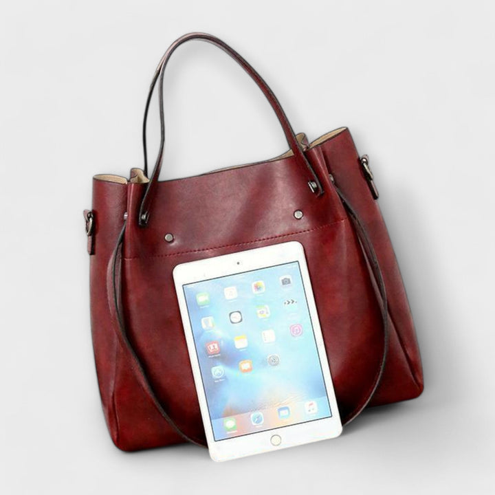 Detail shot of the Olivia bag set hardware and zipper closures in gold tone