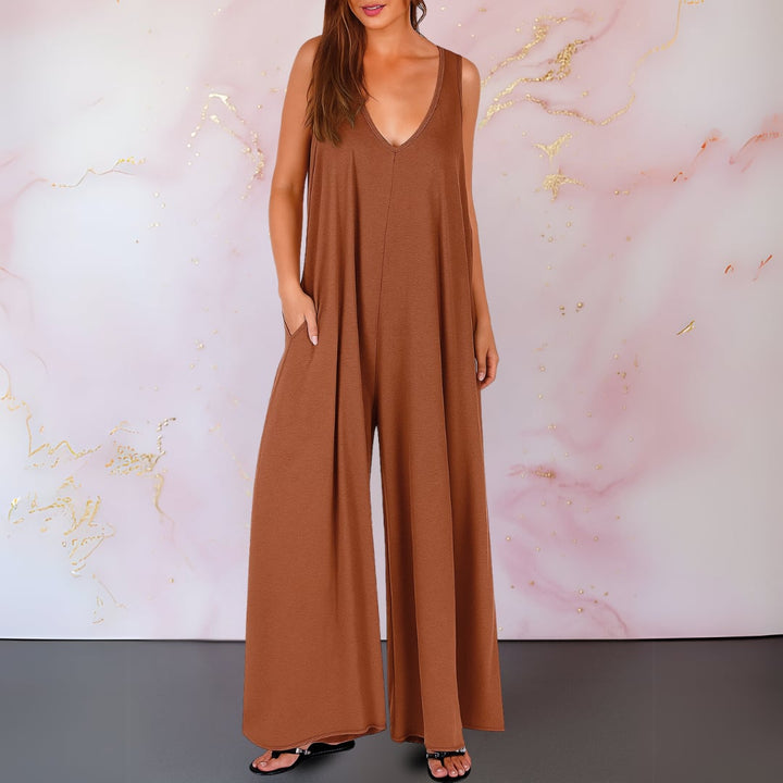 Woman wearing a white sleeveless V-neck wide-leg jumpsuit, full-length front view