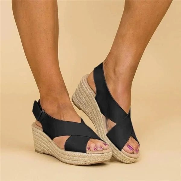 Paloma espadrille wedge sandal in black, three-quarter angle view showing strap detail and wedge height