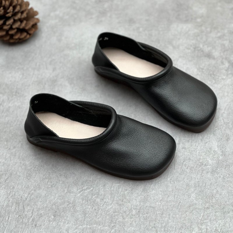 Pearl flat sandals in black, top-down view highlighting minimal strap design