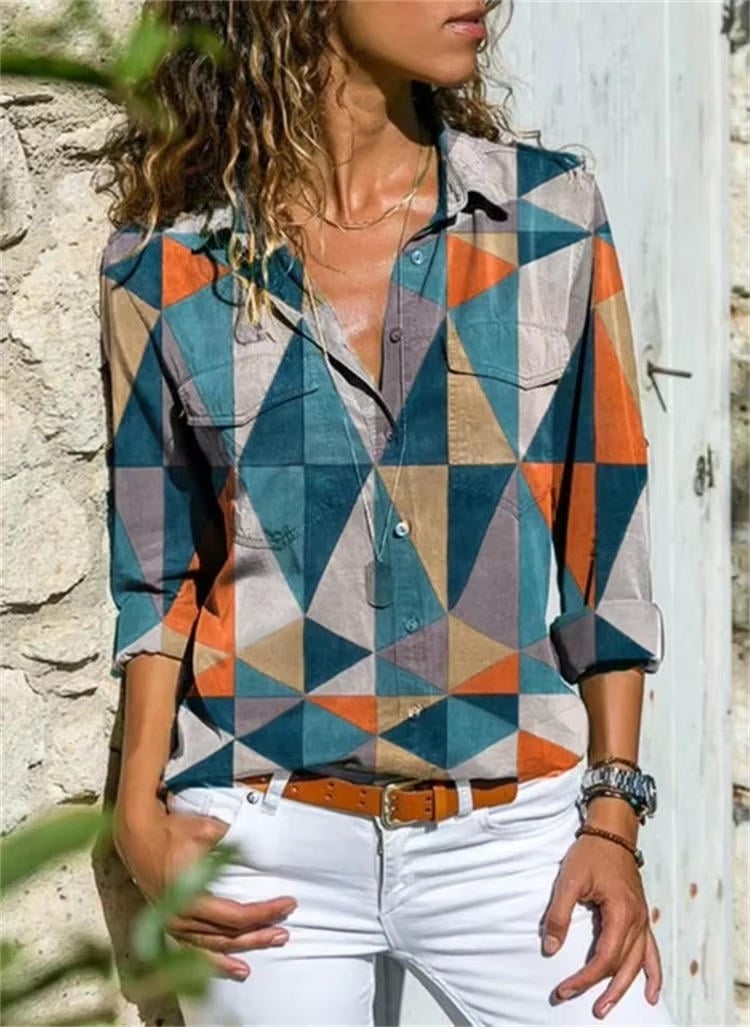 Woman wearing the Petra geometric color-block button-down shirt in orange with white jeans, front view