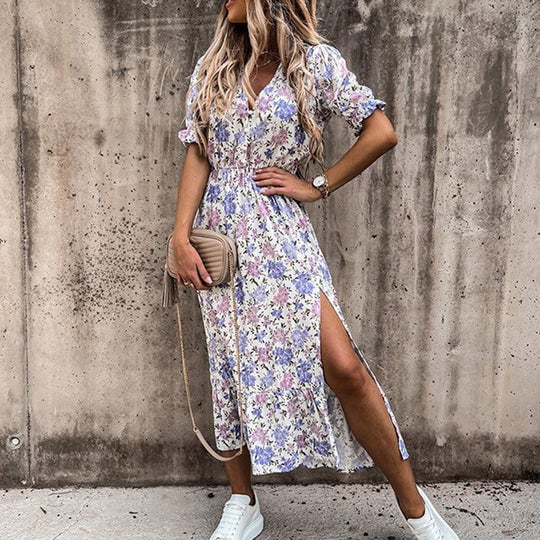 Side view of the Poppy floral midi dress in gray floral print highlighting the side split and midi hem length