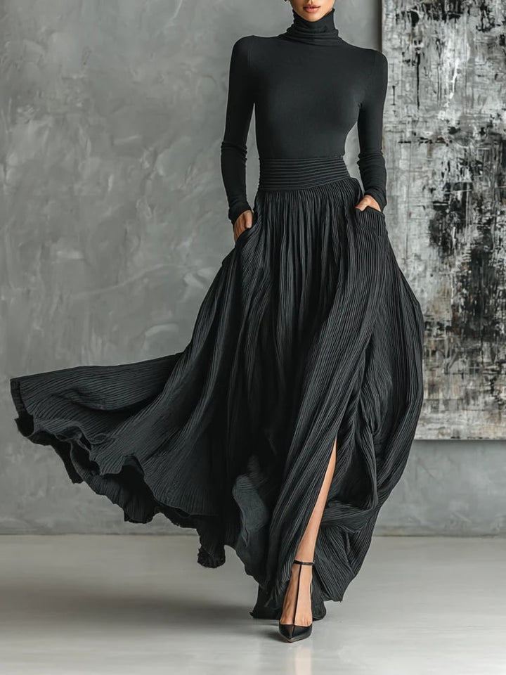 Black slim-fit turtleneck and flowing pleated skirt two-piece set, front flat lay view