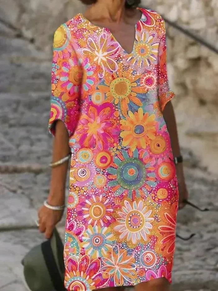 Woman wearing the Quinn floral tummy control dress in yellow, showing relaxed silhouette and full-length floral print