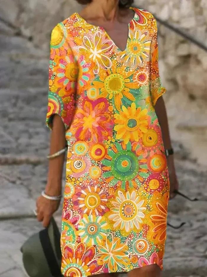 Side view of the Quinn floral dress in green, showcasing the airy lightweight fabric and flattering fit through the hips